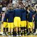Camera crews surround Michigan as the huddle before after warm ups at Assembly Hall on Saturday, Feb. 2 in Bloomington, Ind. Melanie Maxwell I AnnArbor.com
